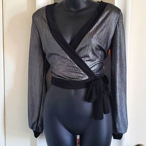 Long sleeve silver top with arm cutout.